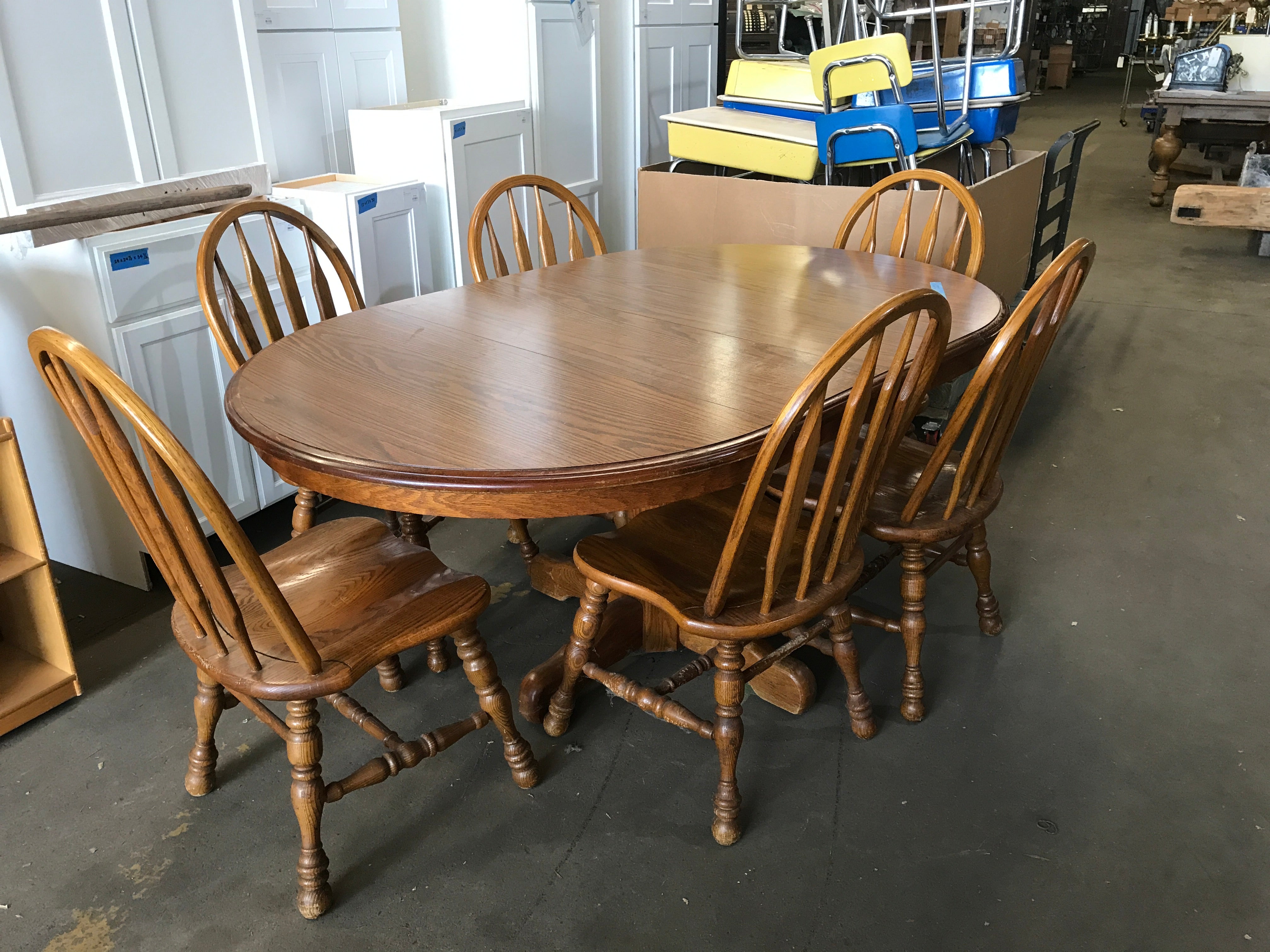 Round Oak Pedestal Dining Table with six chairs, two leaves