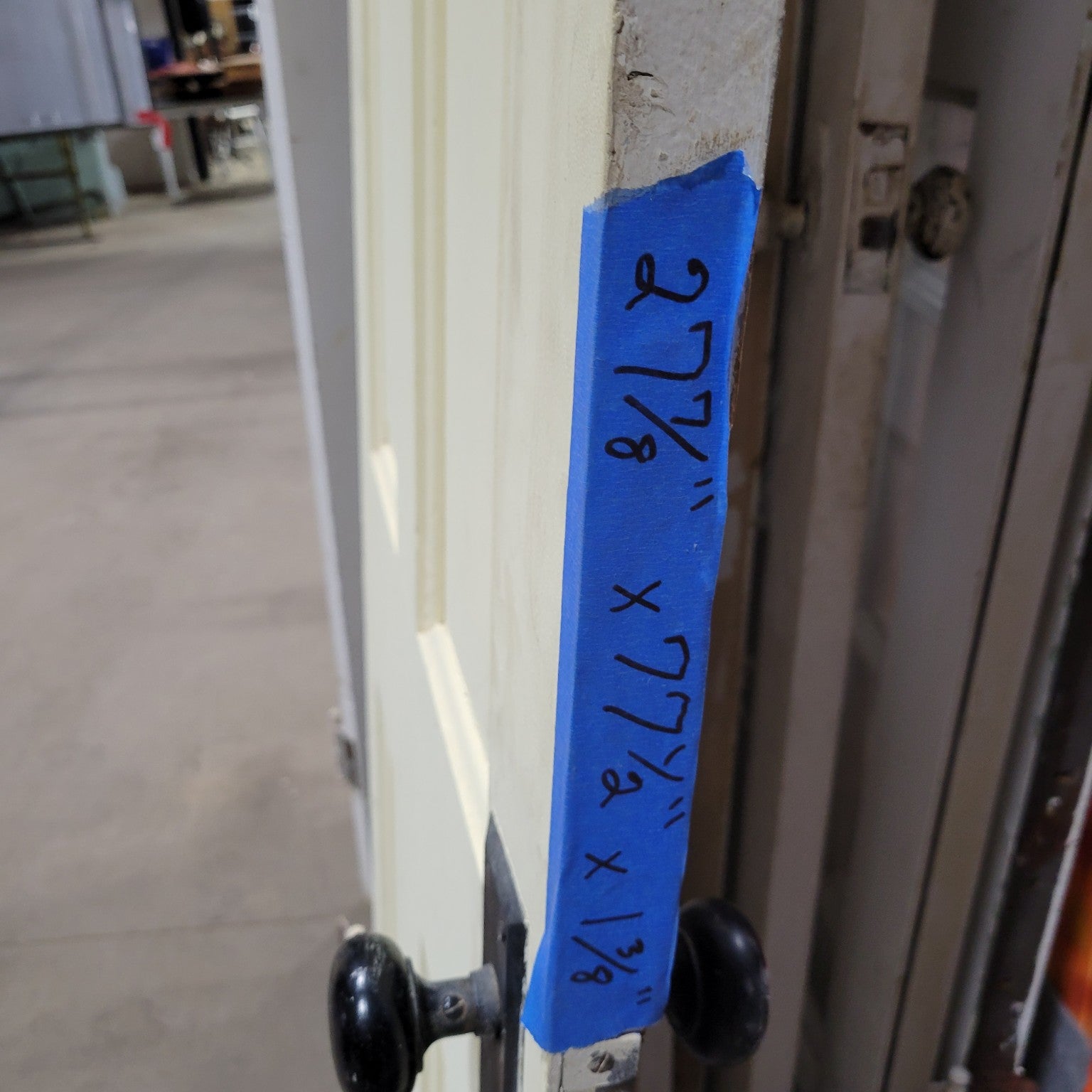 Four-Panel Wooden Door with Black Hardware