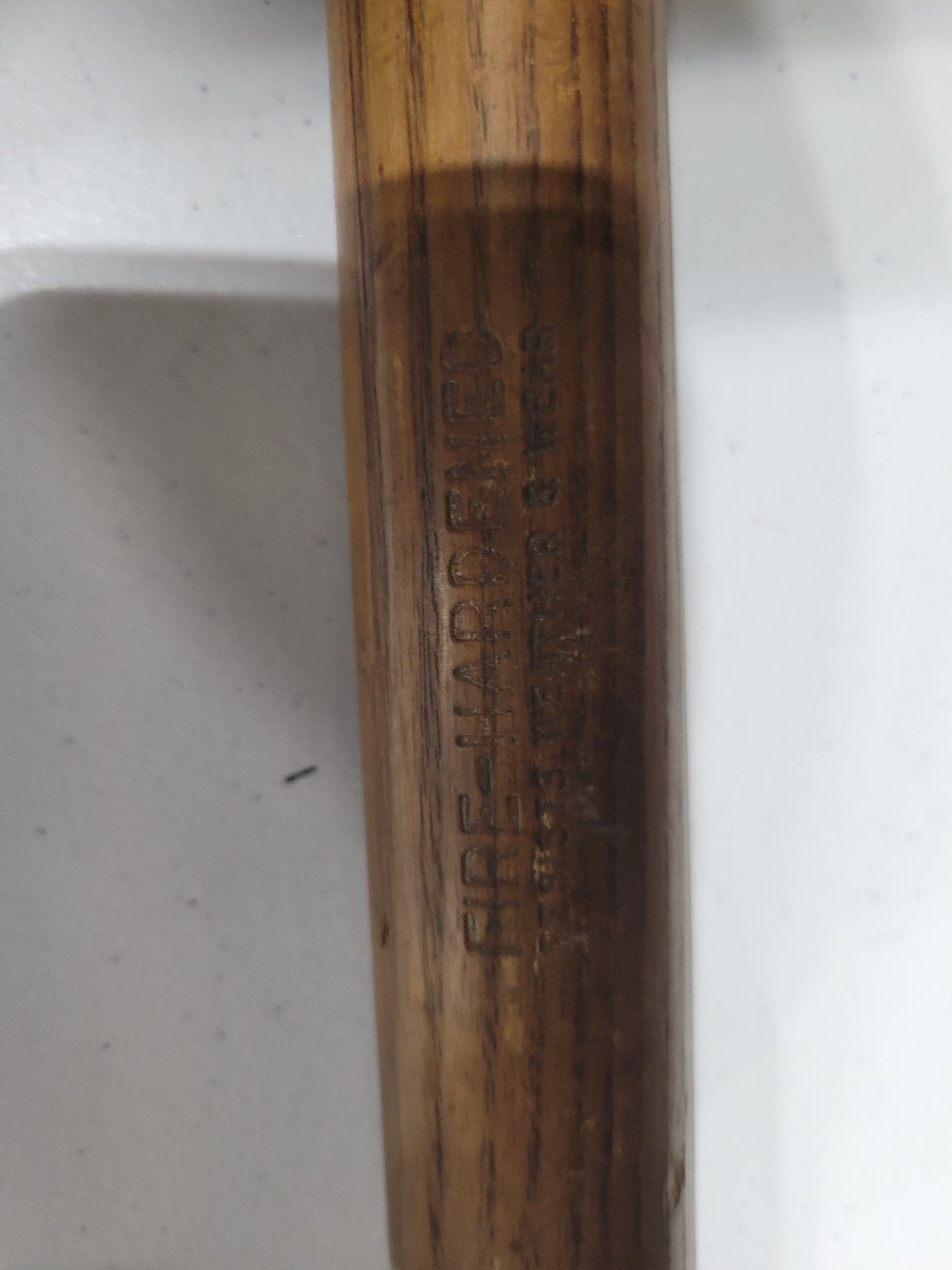 Vintage Agricultural Scythe with Curved Blade and Weathered Wooden Handle