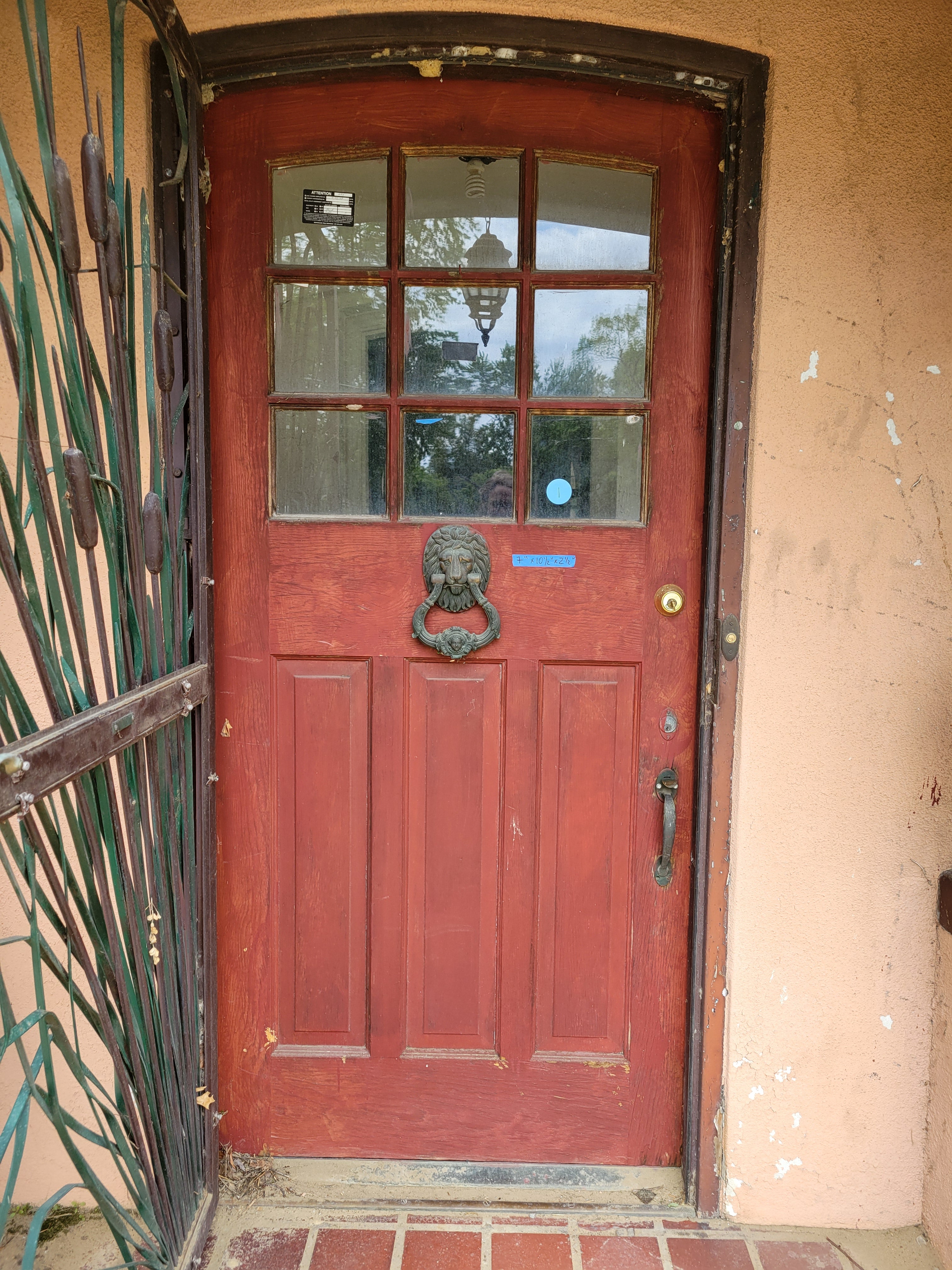 1913 Arched Top Divided Lite Entry Door with Lion Head Knocker