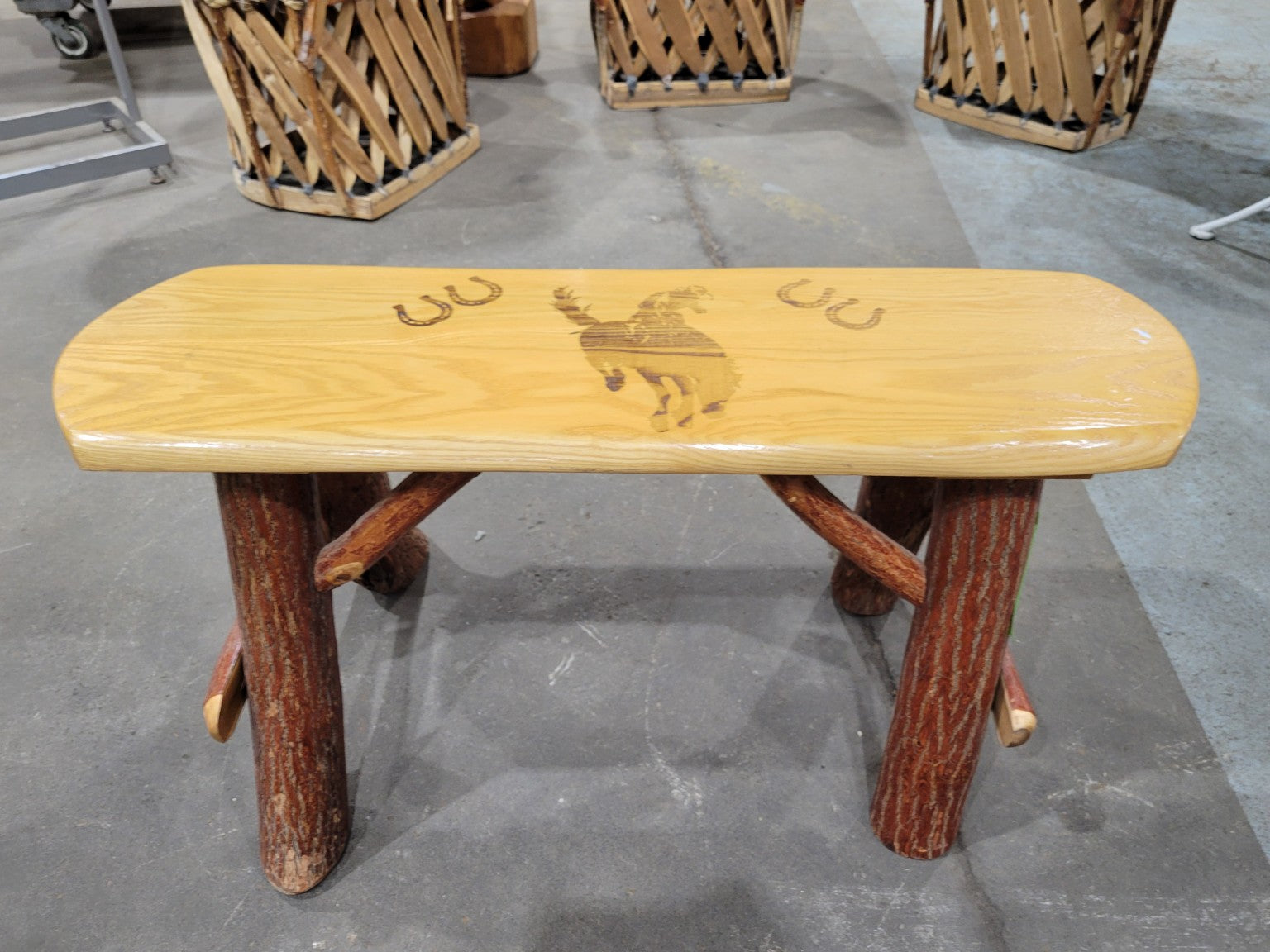 Rustic Log Bench with Bucking Horse Motif