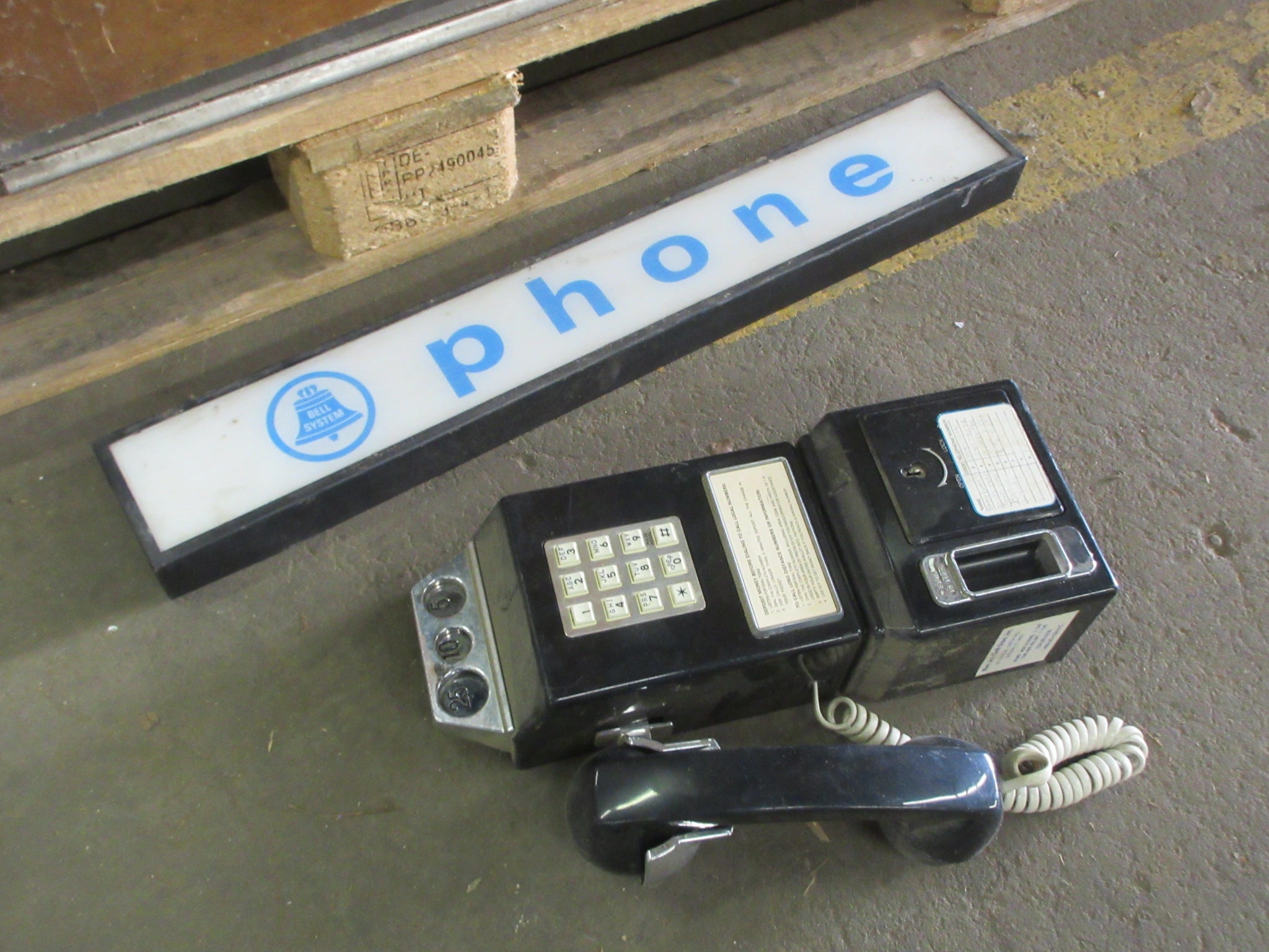 Wooden Phone Booth with Phone and Sign